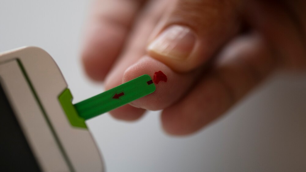 Close up on diabetic person checking their glucose levels